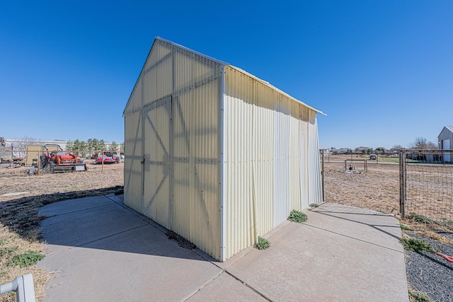 view of outbuilding with an outbuilding and fence