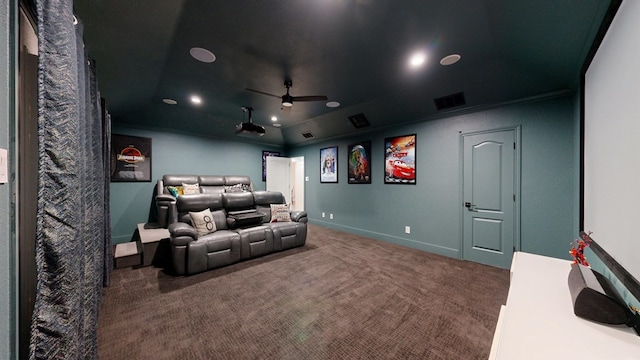 carpeted cinema featuring visible vents, crown molding, baseboards, and ceiling fan