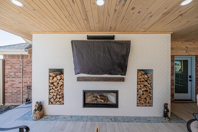 interior space with a glass covered fireplace and recessed lighting