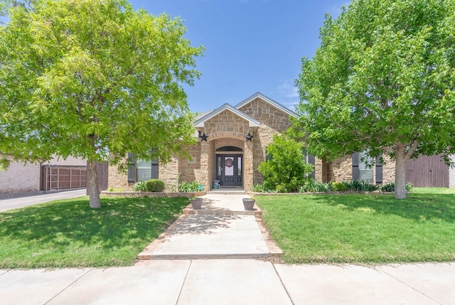 5305 Deer Run, Midland, TX 79707 - view of front facade with stone siding and a front lawn