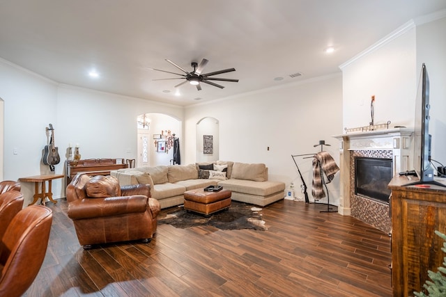 5305 Deer Run, Midland, TX 79707 - living room featuring arched walkways, a tiled fireplace, dark wood finished floors, ceiling fan, and recessed lighting