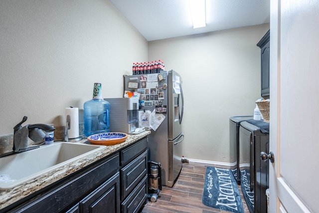 5305 Deer Run, Midland, TX 79707 - laundry room with washing machine and clothes dryer, dark wood finished floors, cabinet space, and baseboards