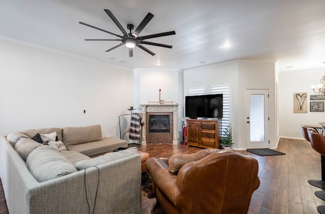5305 Deer Run, Midland, TX 79707 - living room with a chandelier, a glass covered fireplace, dark wood-style flooring, a ceiling fan, and ornamental molding