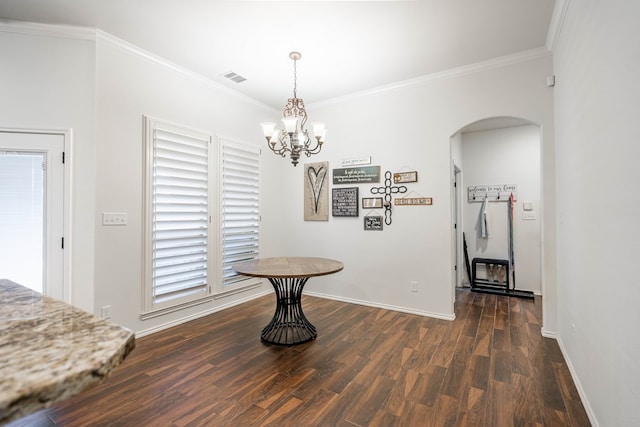 5305 Deer Run, Midland, TX 79707 - dining room featuring arched walkways, dark wood-style flooring, ornamental molding, a chandelier, and baseboards