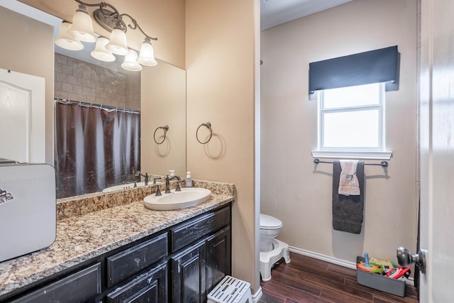 5305 Deer Run, Midland, TX 79707 - full bath with toilet, baseboards, wood finished floors, vanity, and curtained shower
