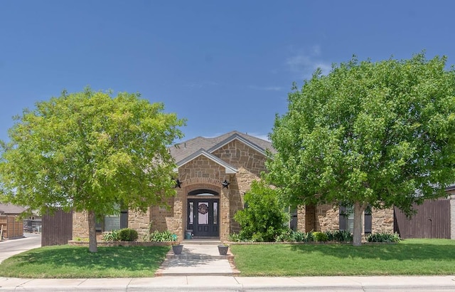 5305 Deer Run, Midland, TX 79707 - view of front facade featuring stone siding and a front lawn