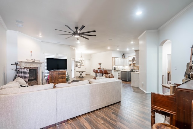 5305 Deer Run, Midland, TX 79707 - living area featuring ceiling fan, a premium fireplace, arched walkways, dark wood-style flooring, and ornamental molding