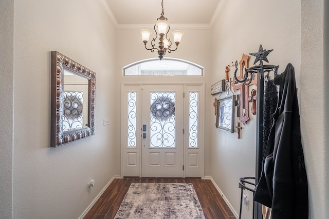 5305 Deer Run, Midland, TX 79707 - foyer with a chandelier, dark wood-type flooring, crown molding, and baseboards