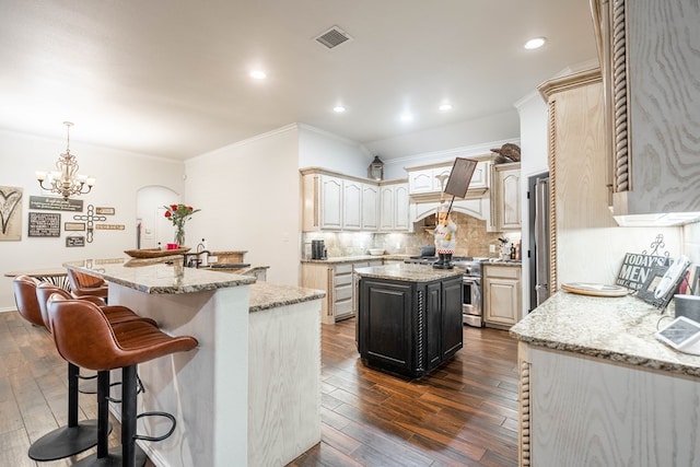 5305 Deer Run, Midland, TX 79707 - kitchen featuring a center island with sink, stainless steel appliances, a chandelier, ornamental molding, and decorative backsplash