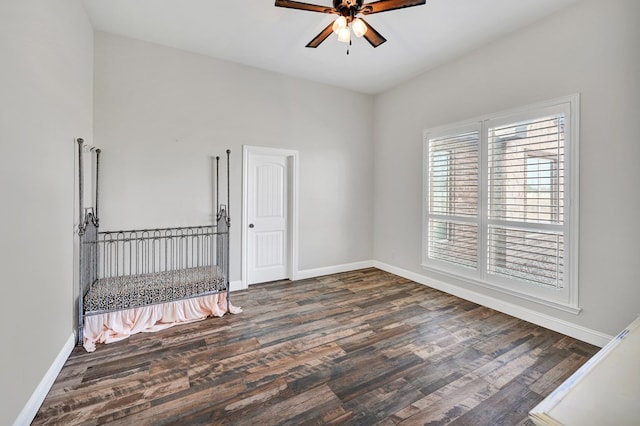 7704 W County Rd 52 Unit A, Midland, TX 79707 - empty room with a ceiling fan, dark wood-style floors, and baseboards