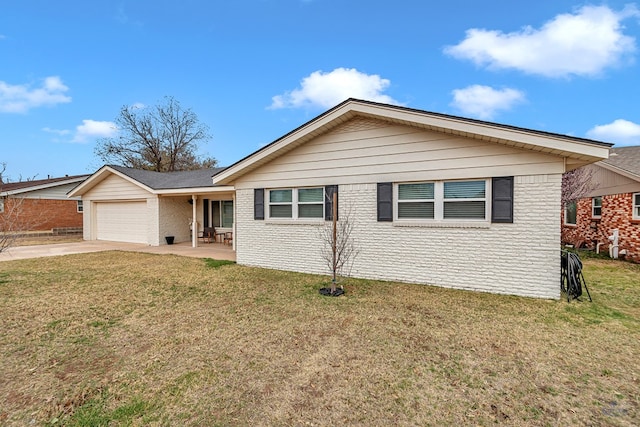 ranch-style home with a garage, brick siding, driveway, and a front lawn