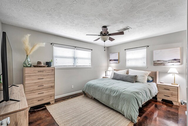 bedroom with visible vents, concrete floors, baseboards, and multiple windows