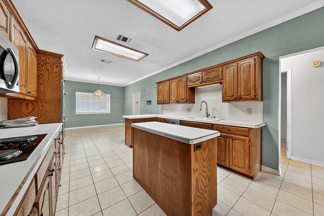 2209 Southampton Ln, Midland, TX 79705 - kitchen featuring appliances with stainless steel finishes, light tile patterned floors, a textured ceiling, backsplash, and light countertops