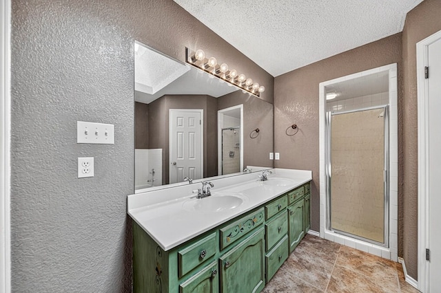 2209 Southampton Ln, Midland, TX 79705 - bathroom with a textured wall, double vanity, a stall shower, tile patterned flooring, and a textured ceiling