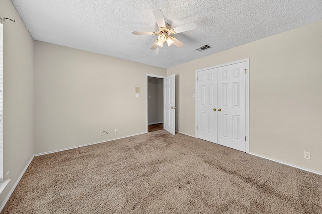2209 Southampton Ln, Midland, TX 79705 - unfurnished bedroom featuring a textured ceiling, carpet, a closet, and a ceiling fan