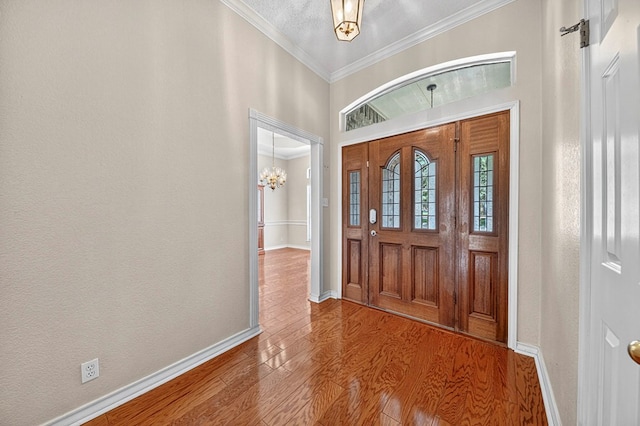 2209 Southampton Ln, Midland, TX 79705 - entrance foyer with ornamental molding, wood finished floors, and a chandelier
