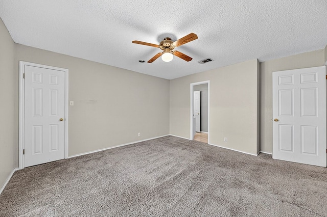2209 Southampton Ln, Midland, TX 79705 - unfurnished bedroom featuring carpet floors, a textured ceiling, and a ceiling fan
