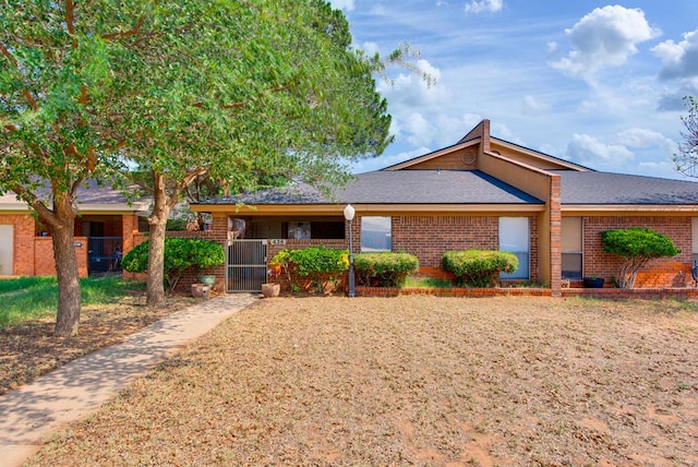 438 W Pine Ave, Midland, TX 79705 - single story home featuring brick siding, a gate, and a shingled roof