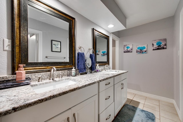 438 W Pine Ave, Midland, TX 79705 - full bathroom with double vanity and tile patterned floors