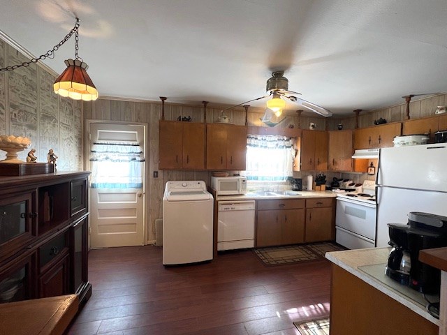 3702 Dalton Dr, Snyder, TX 79549 - kitchen with under cabinet range hood, light countertops, white appliances, and washer / dryer