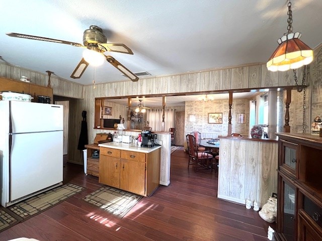 3702 Dalton Dr, Snyder, TX 79549 - kitchen featuring wallpapered walls, light countertops, freestanding refrigerator, and dark wood-style flooring