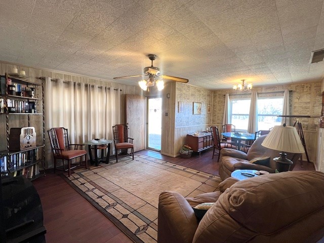 3702 Dalton Dr, Snyder, TX 79549 - living room with ceiling fan with notable chandelier, wood finished floors, and visible vents