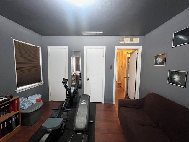3702 Dalton Dr, Snyder, TX 79549 - exercise area featuring wood finished floors and visible vents