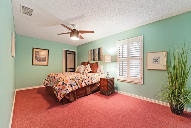 carpeted bedroom with ceiling fan and a textured ceiling