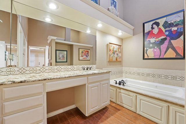 bathroom with vanity and a bathing tub