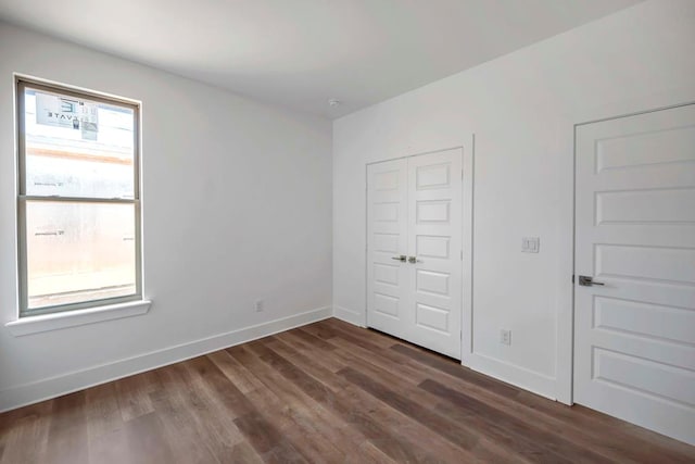 8643 Santa Isabella, Odessa, TX 79765 - unfurnished bedroom with dark wood-type flooring, baseboards, and a closet