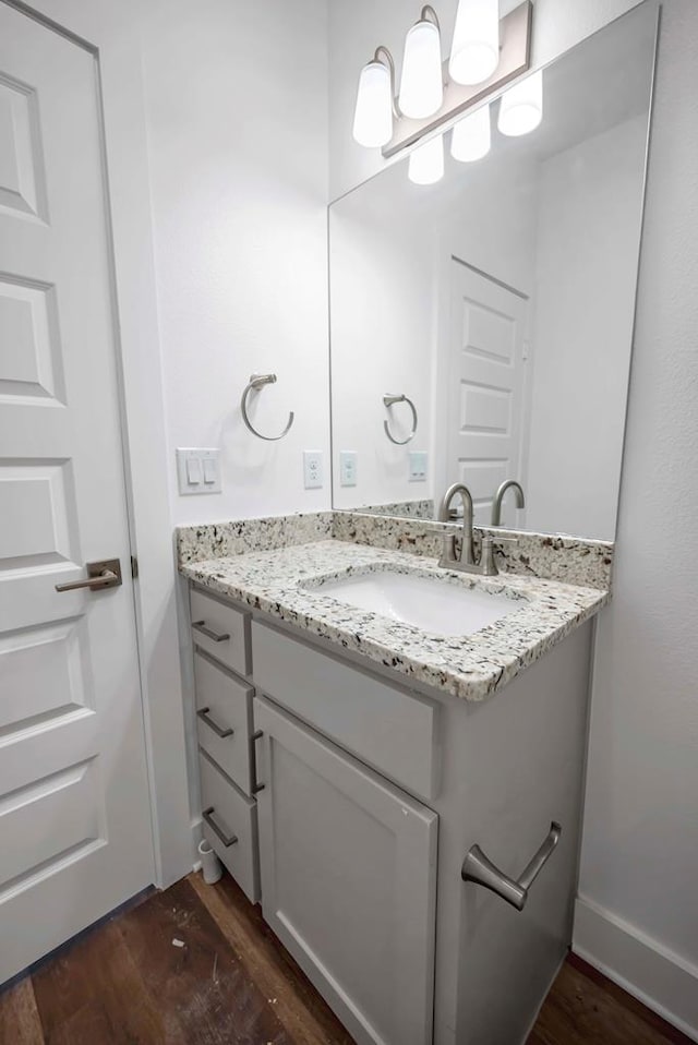 8643 Santa Isabella, Odessa, TX 79765 - bathroom with wood finished floors, vanity, and baseboards