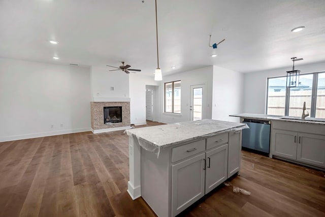 8643 Santa Isabella, Odessa, TX 79765 - kitchen with stainless steel dishwasher, a sink, a ceiling fan, a glass covered fireplace, and recessed lighting