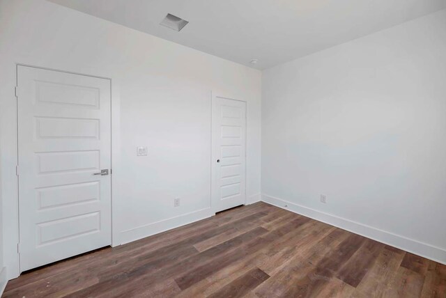 8643 Santa Isabella, Odessa, TX 79765 - unfurnished room featuring baseboards and dark wood-type flooring