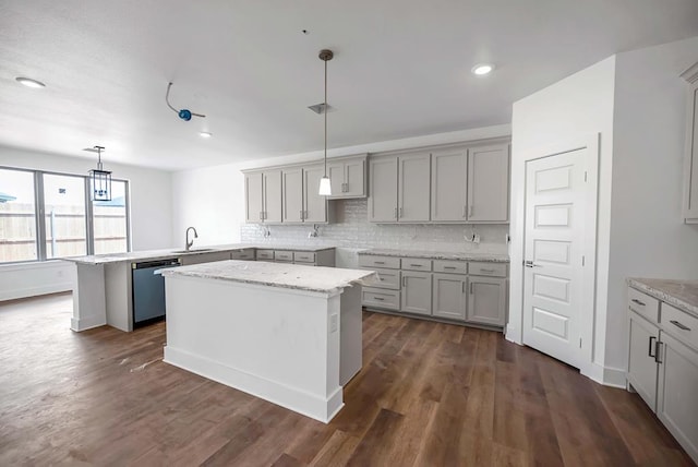 8643 Santa Isabella, Odessa, TX 79765 - kitchen featuring dishwasher, a sink, decorative backsplash, a peninsula, and gray cabinets