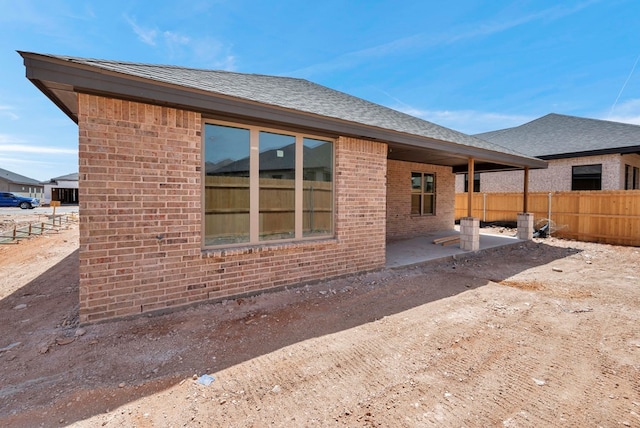 8643 Santa Isabella, Odessa, TX 79765 - back of house with brick siding, fence, a patio, and a shingled roof