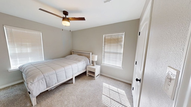 bedroom with carpet, a ceiling fan, and baseboards