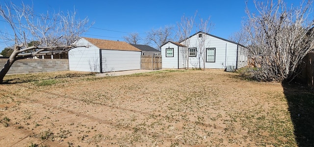 exterior space with cooling unit and fence