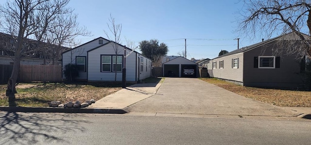 view of front of house featuring a garage, fence, and concrete driveway