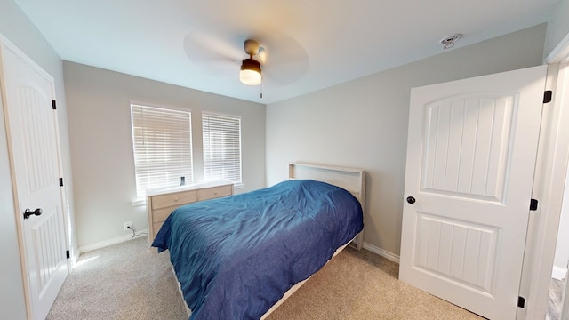 bedroom with a ceiling fan, carpet flooring, and baseboards