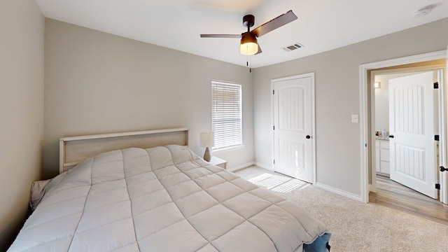 carpeted bedroom with baseboards, visible vents, ceiling fan, and a closet