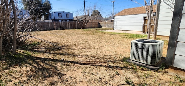 view of yard featuring cooling unit and fence