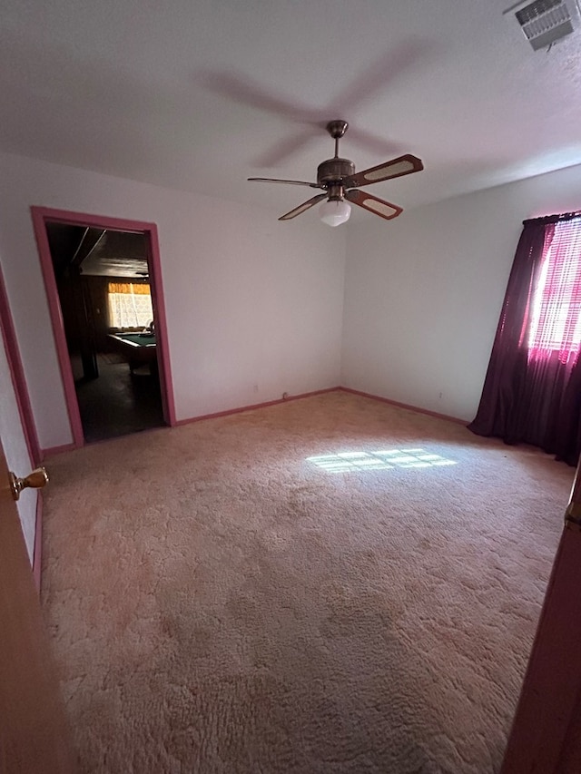 empty room with carpet floors and ceiling fan