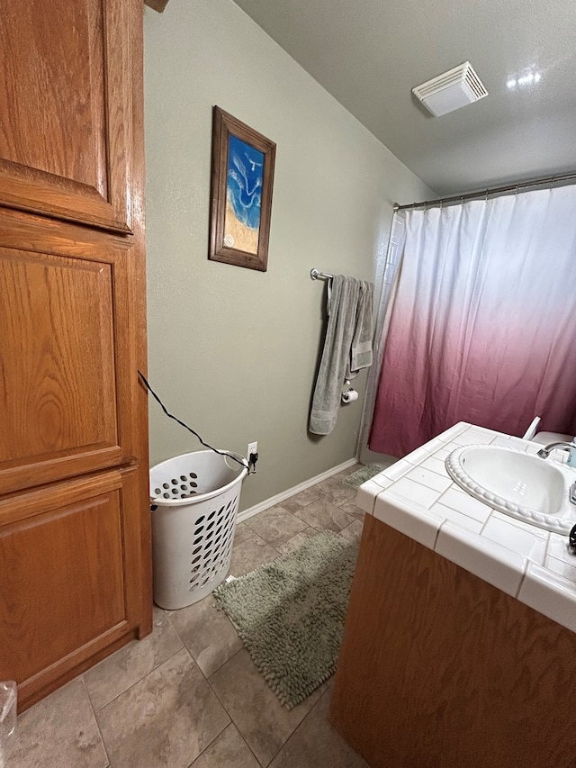 bathroom with tile patterned flooring, vanity, and a shower with shower curtain