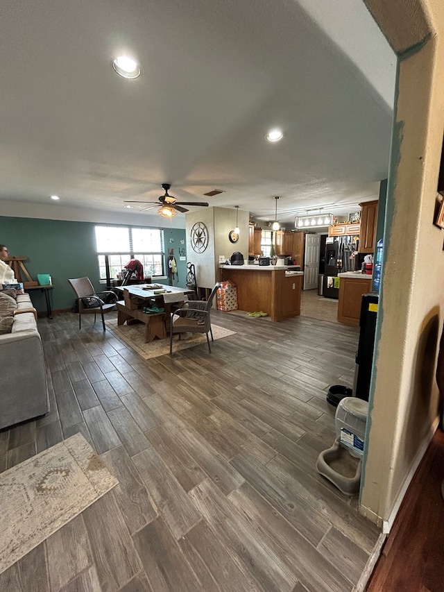 living room featuring dark hardwood / wood-style floors and ceiling fan