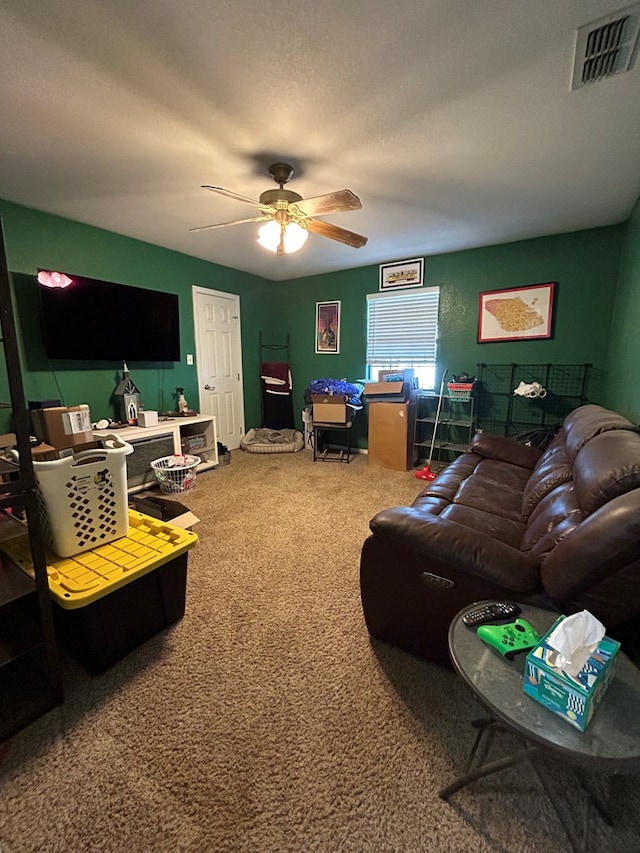 living room with carpet, a textured ceiling, and ceiling fan