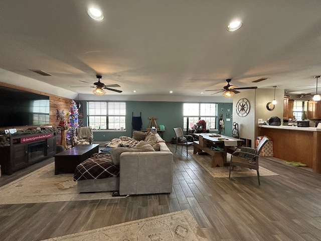 living room with ceiling fan and dark hardwood / wood-style flooring