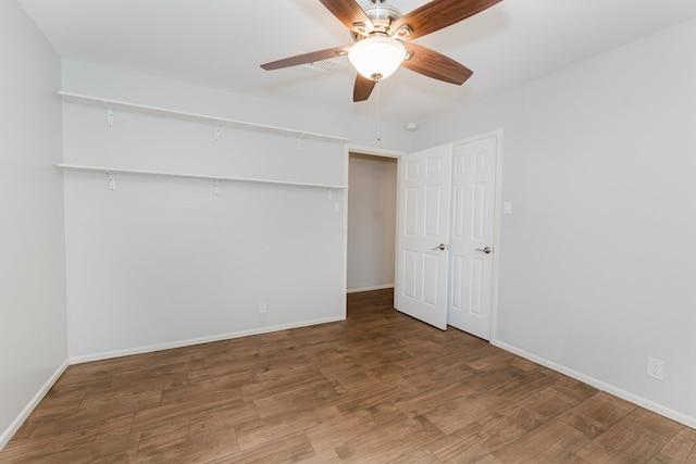 unfurnished bedroom featuring hardwood / wood-style floors and ceiling fan