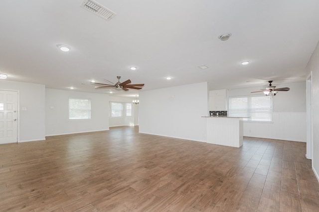 unfurnished living room featuring ceiling fan and wood-type flooring