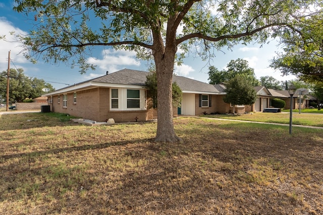 ranch-style home with central AC and a front lawn