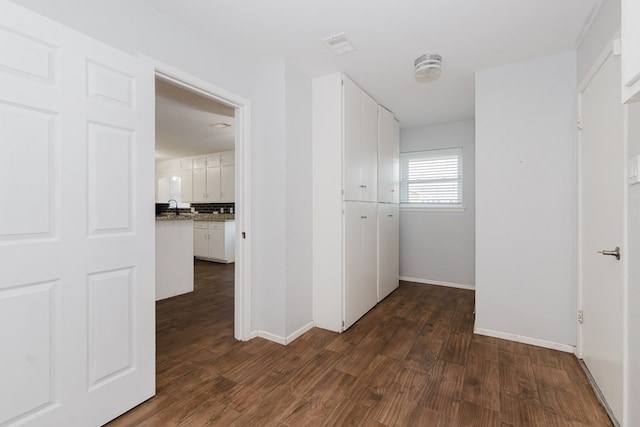 corridor with dark wood-type flooring